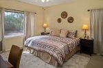 The master bedroom is cozy with a king size bed
